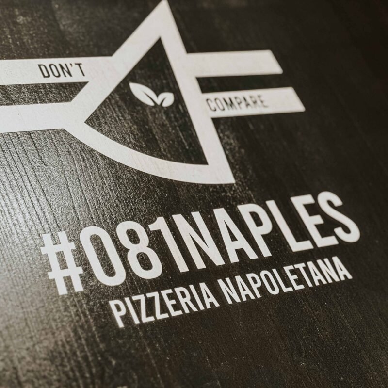 Wooden restaurant sign with printed logo and text, custom made for hospitality use.