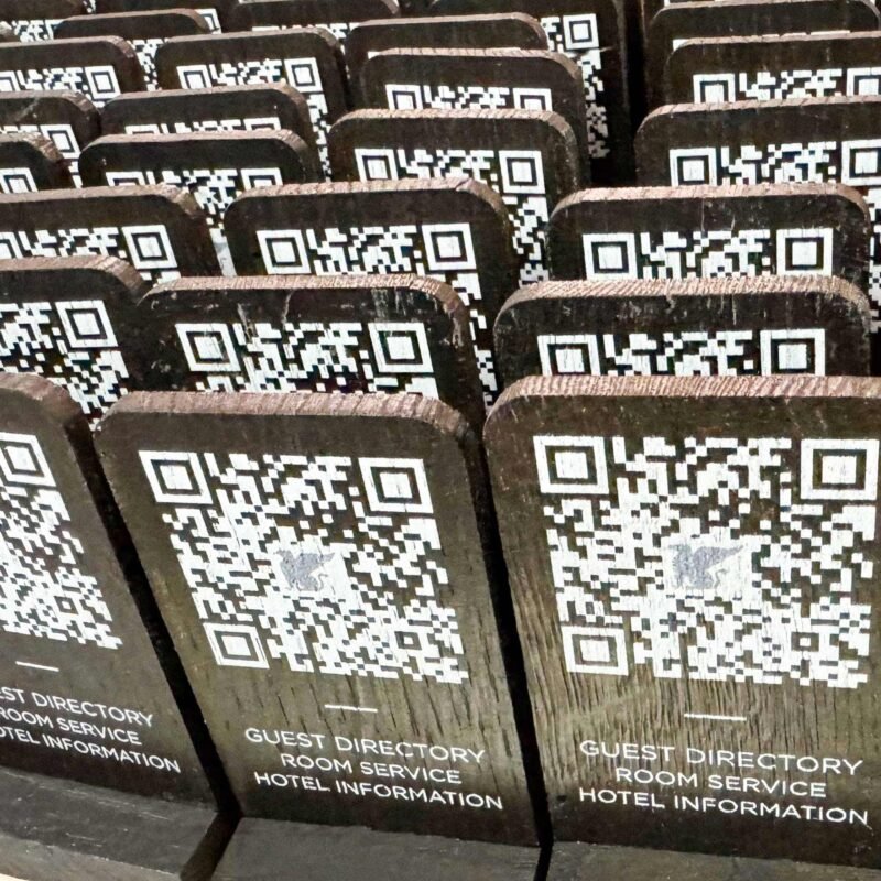 Wooden QR code cards with white UV print, custom-made for branding and digital access.